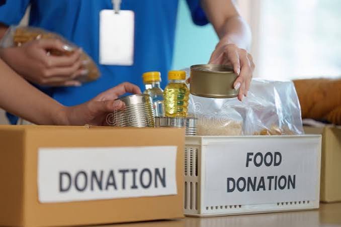 Volunteers packing ration bags in a warehouse
